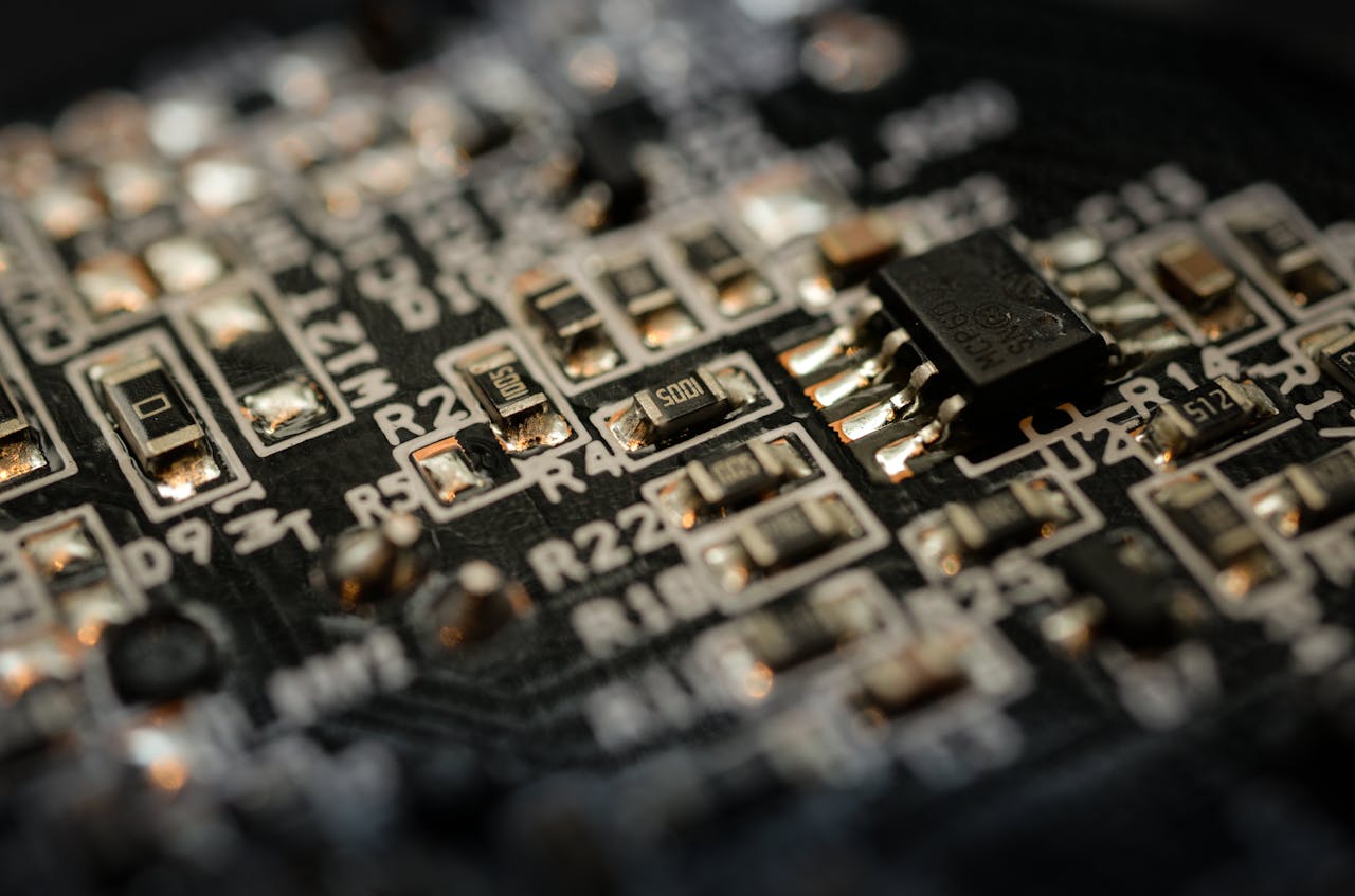 Detailed close-up of a microchip on an electronic circuit board with components and connections.
